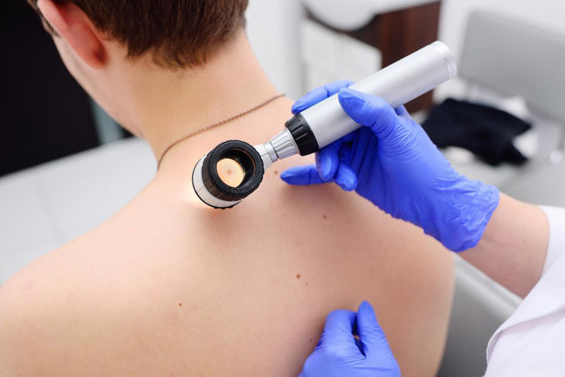A doctor conducts an examination of a man's back